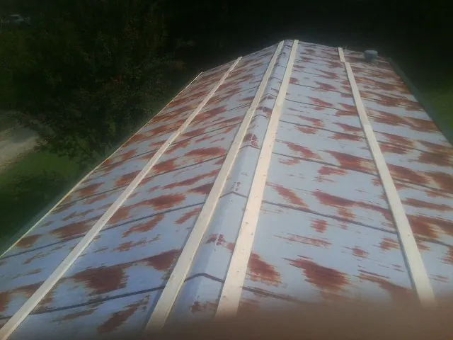 Rusted metal roof panels with new wood purlins before replacement — Storm Damage Roof Repair in Weatherford by Roofing Brothers
