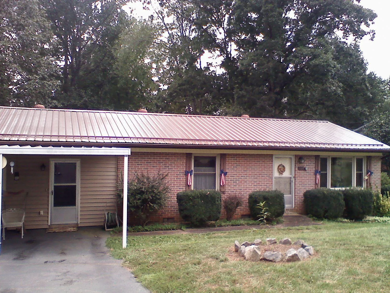 Bronze metal roof and carport on a brick ranch home — Roof Repair work by our crew in Weatherford
