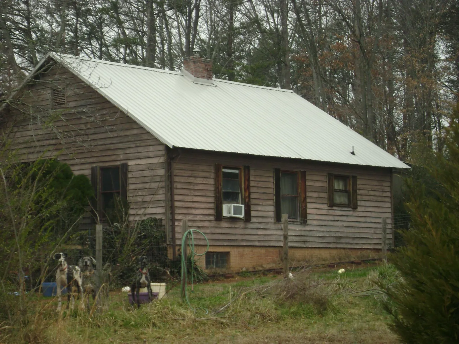 White metal roof on an old wood sided farmhouse, from a Metal Roof Installation job in Weatherford